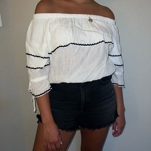 off the shoulder white ruffle shirt